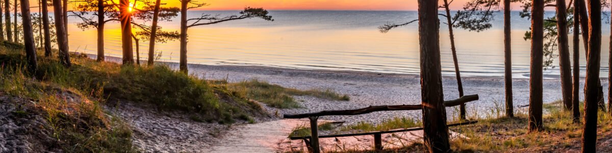 Wooden footpath leading to a beach of the Baltic Sea. Concept of happy, bliss and healthy summer vacation in ecologically clean Baltic region of Eastern Europe, Jurmala, Latvia